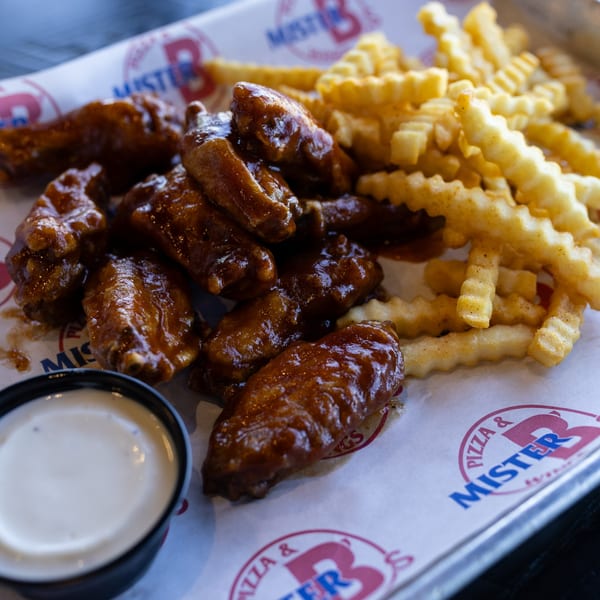 Mister B's Pizza & Wings' BBQ chicken wings, crinkle-cut fries, and a side of ranch dressing.
